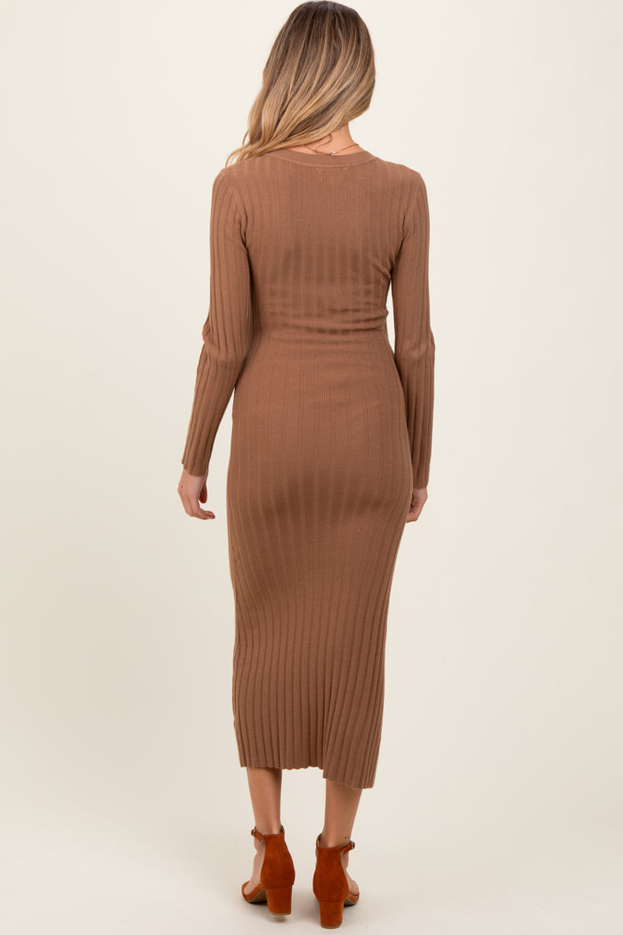 woman wearing a brown ribbed long sleeve maternity dress that reaches mid-calf length