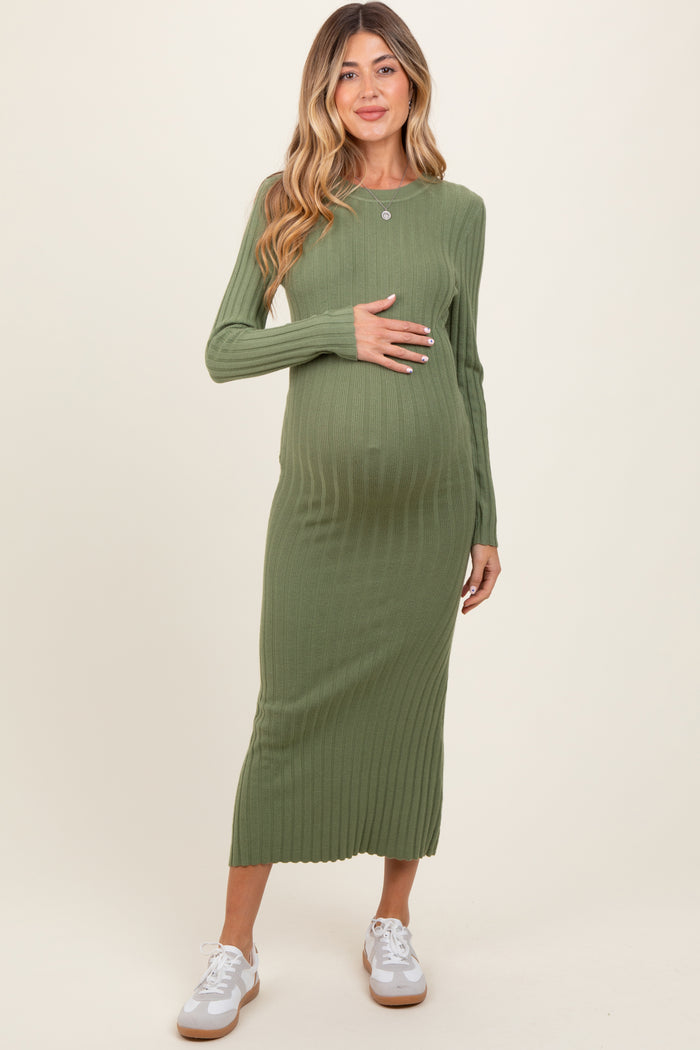 woman wearing a green ribbed maternity dress with long sleeves and a baby bump