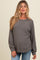 woman wearing a gray maternity sweatshirt with long sleeves and a relaxed fit, showing her baby bump