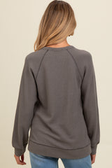woman wearing a gray waffle knit maternity sweatshirt, view from the back