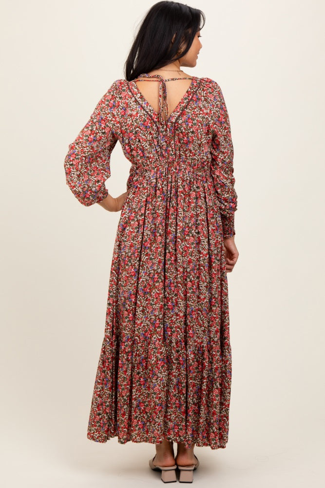 woman wearing a floral long sleeve maxi dress with a smocked back and tie detail, viewed from the back