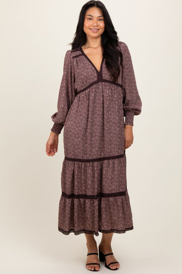 woman wearing a floral long sleeve maxi dress with a deep v-neck and tiered skirt