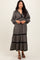 woman wearing a black floral long sleeve maxi dress with a tiered skirt and a v-neckline