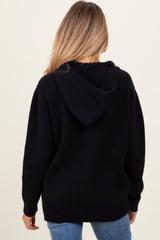 woman wearing a black maternity hoodie with a relaxed fit and a hood, viewed from the back