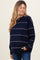 woman wearing a navy blue striped maternity sweater with a relaxed fit and long sleeves