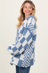woman wearing a blue and white checkered oversized cardigan with wide sleeves and a relaxed fit