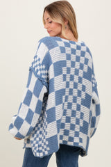 woman wearing a blue and white checkered oversized sweater, showing the back and relaxed fit