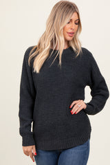 woman wearing a dark gray textured oversized sweater with long sleeves and a relaxed fit