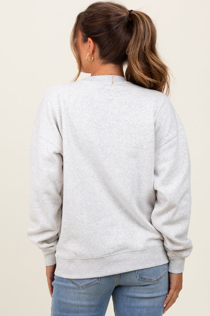 woman wearing a light gray maternity sweatshirt with a relaxed fit and long sleeves, view from the back