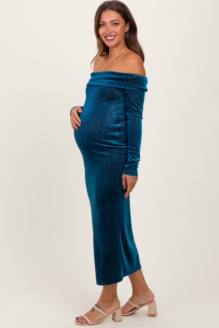 woman wearing a teal off-the-shoulder maternity dress, showcasing her baby bump, with a fitted silhouette and long sleeves