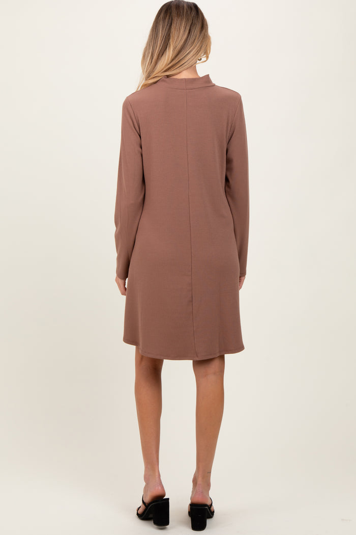 woman wearing a brown long sleeve maternity dress, shown from the back, with a relaxed fit and above-the-knee length