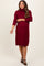woman wearing a burgundy maternity turtleneck sweater dress with a relaxed fit and a visible baby bump