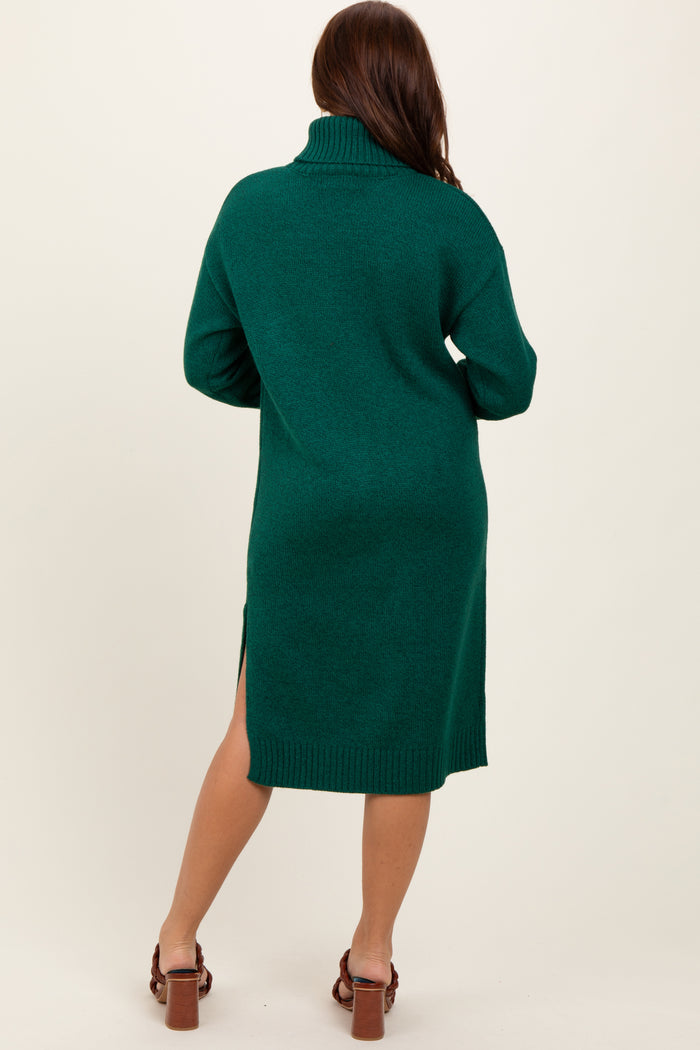 woman wearing a green oversized turtleneck sweater dress with side slits
