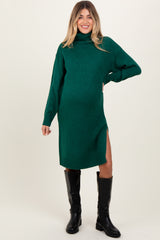 woman wearing a green turtleneck maternity dress with side slits and showing her baby bump