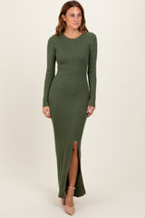 woman wearing an olive green ribbed maxi dress with long sleeves and a front slit