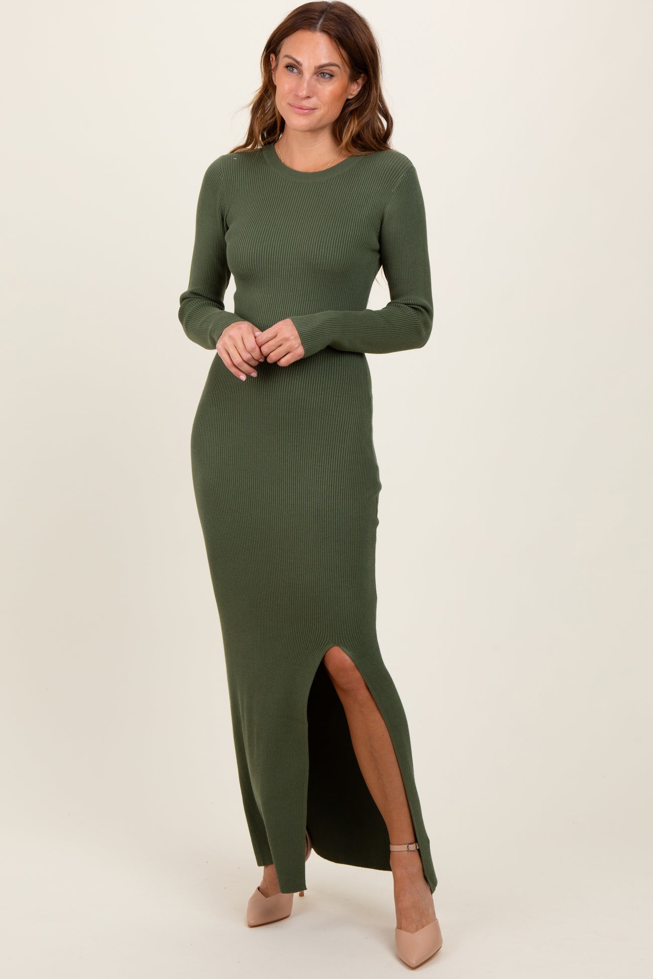 woman wearing a long sleeve olive green ribbed maxi dress with a side slit and straight fit