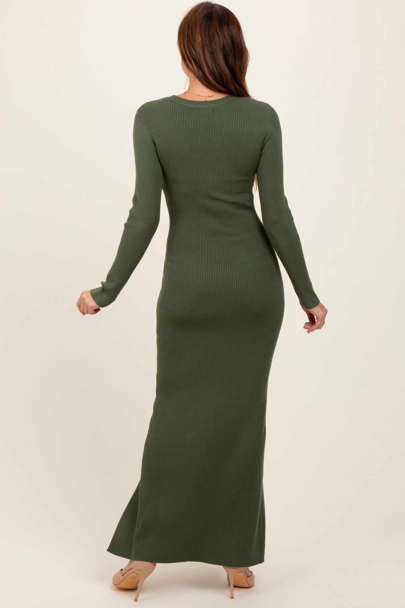 woman wearing a fitted olive green ribbed maxi dress with long sleeves, viewed from the back