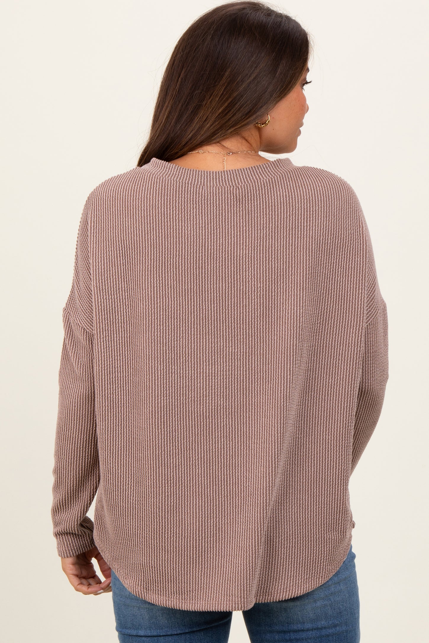 woman wearing a mauve ribbed maternity sweater with a relaxed fit
