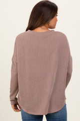woman wearing a mauve ribbed maternity sweater with a relaxed fit