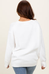 woman wearing a cozy white oversized sweater with dropped shoulders and ribbed hem, seen from the back