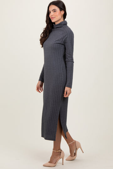 woman wearing a dark gray long sleeve midi dress with a turtle neck and side slit, styled with beige high heels