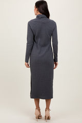 woman wearing a long gray sweater dress with a fitted silhouette and side slits, viewed from the back