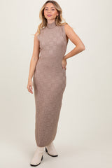 woman wearing a brown sleeveless knitted midi dress with a textured check pattern and standing in a neutral pose
