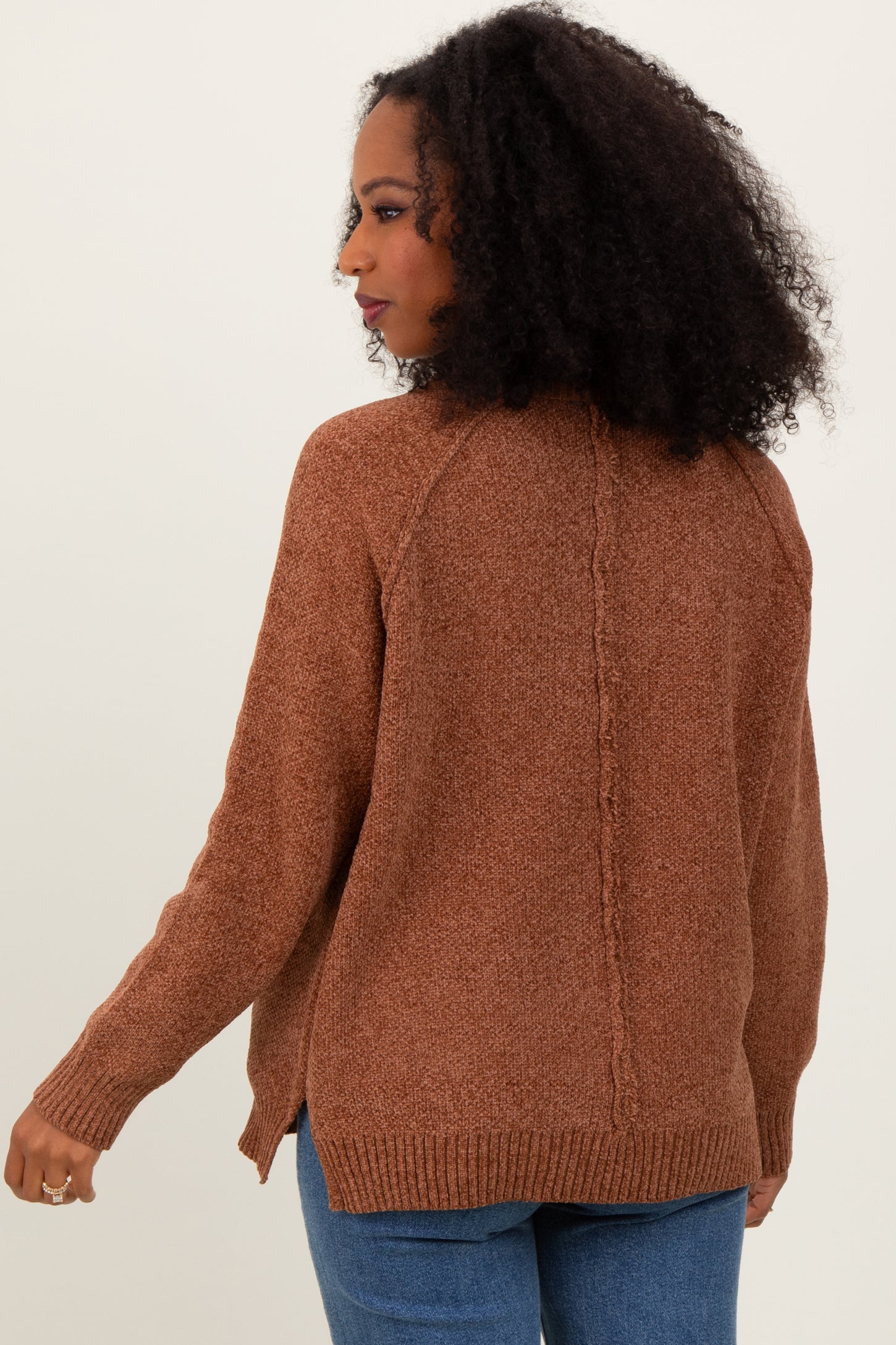 woman wearing a brown textured cardigan sweater with a relaxed fit and side slits