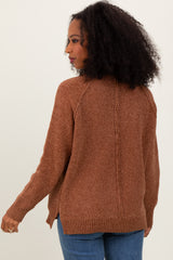 woman wearing a brown textured cardigan sweater with a relaxed fit and side slits
