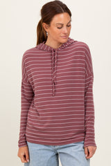 woman wearing a maroon striped pullover hoodie with a drawstring and relaxed fit