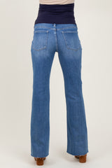 woman wearing light blue maternity flared jeans, viewed from the back
