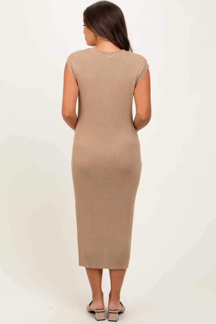 woman wearing a beige ribbed maternity dress, fitted style, visible baby bump, seen from the back
