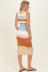 woman wearing a sleeveless multi-colored striped midi dress with a fitted silhouette and a ribbed texture