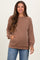 woman wearing a brown ribbed maternity sweater with front pockets and a relaxed fit, smiling at the camera