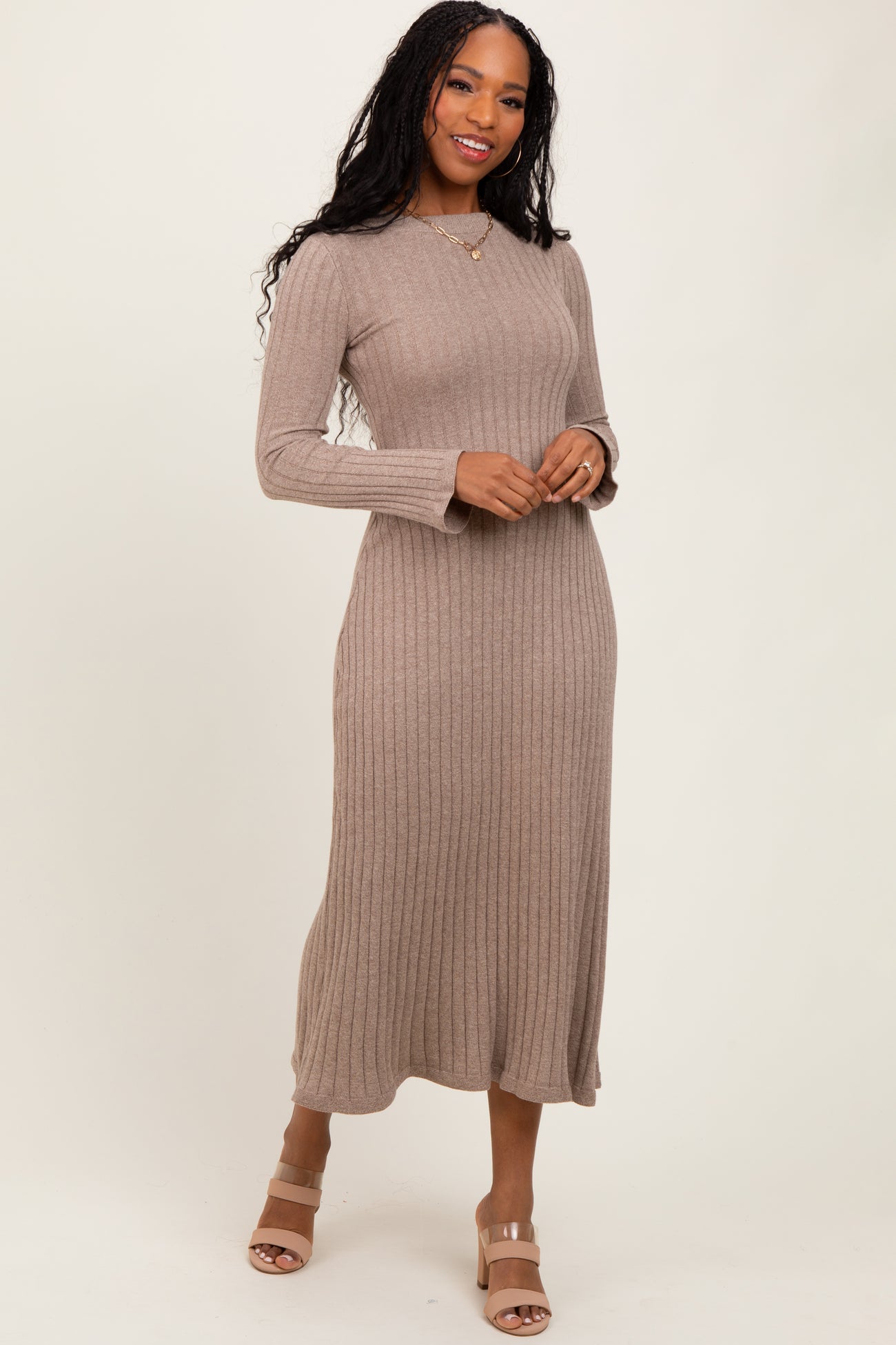 woman wearing a taupe ribbed long sleeve midi dress and tan block heel sandals