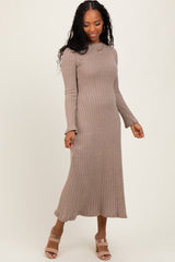 woman wearing a taupe ribbed midi dress with long sleeves and a fitted silhouette, paired with beige block-heeled sandals