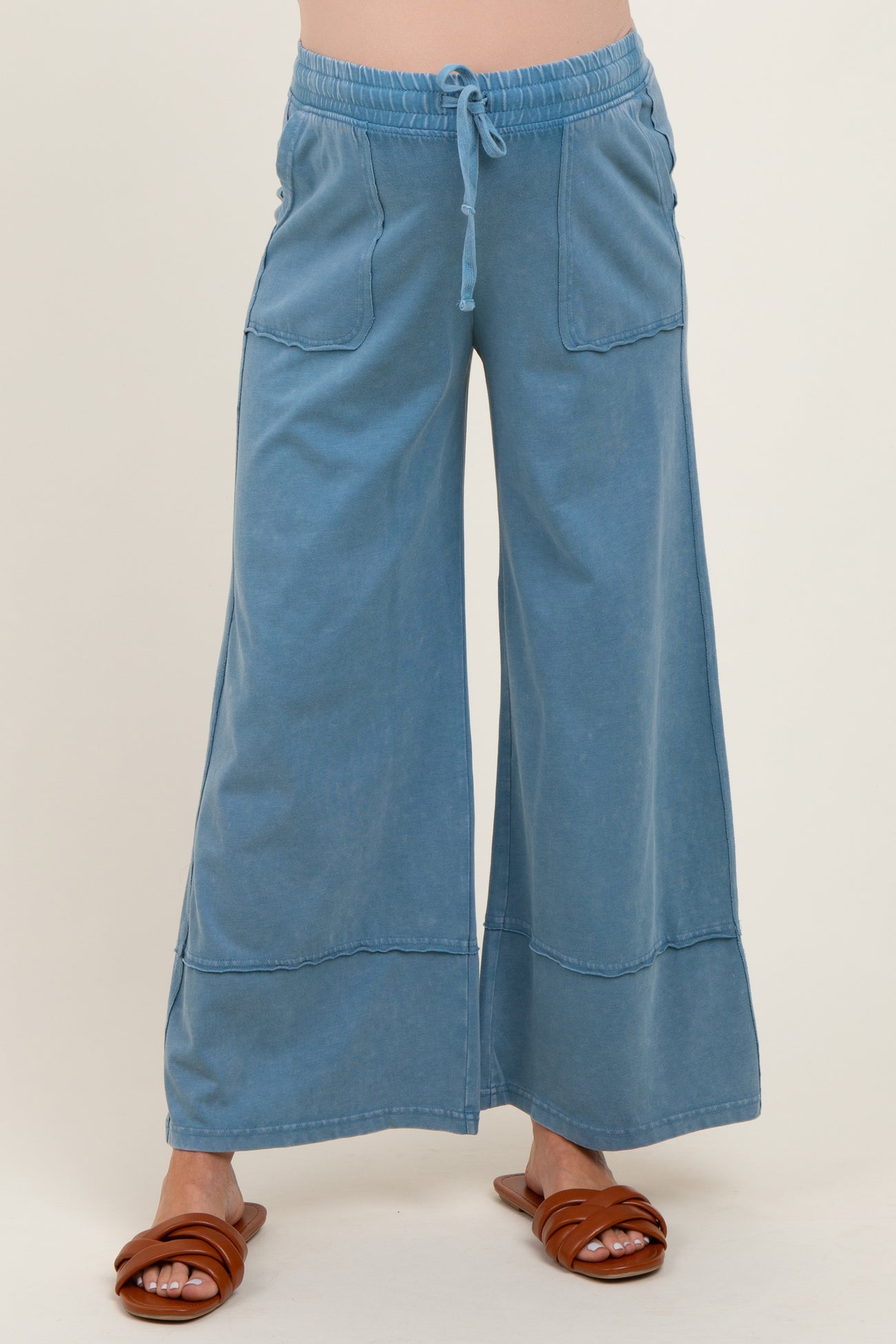 woman wearing light blue wide-leg maternity pants with pockets and drawstring waistband