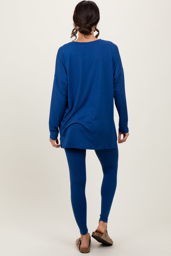 woman wearing a blue long sleeve oversized top and matching blue leggings, turned away from the camera