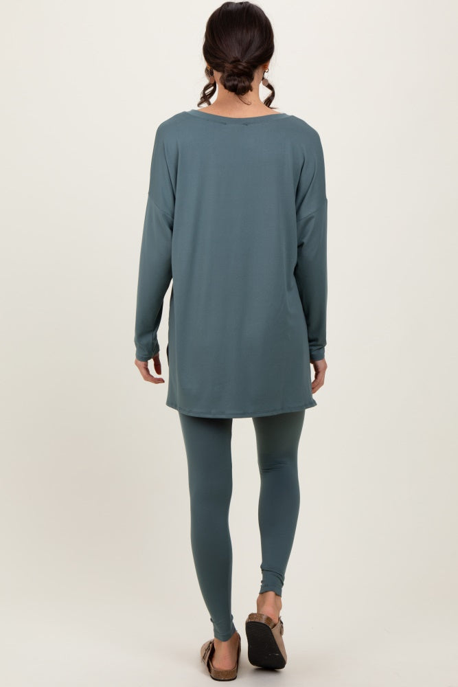 woman wearing a long sleeve teal top and matching teal leggings, seen from the back