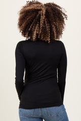 woman wearing a black long sleeve maternity top, showing the back view with gathered detail on the sides