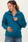woman wearing a teal maternity sweater with a half zip and relaxed fit, showing her baby bump