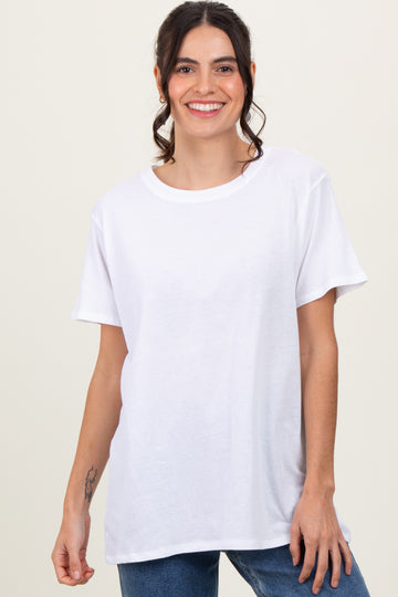 woman wearing a white short sleeve t-shirt with a relaxed fit and smiling at the camera