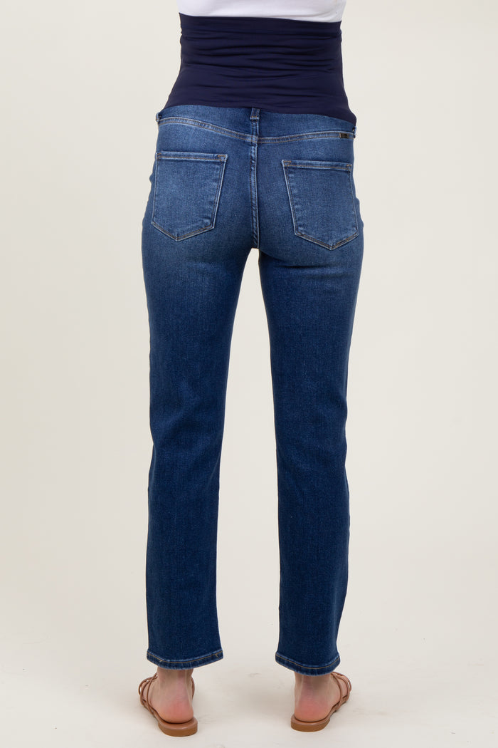 woman wearing dark blue maternity jeans from the back, featuring a comfortable waistband and slim fit