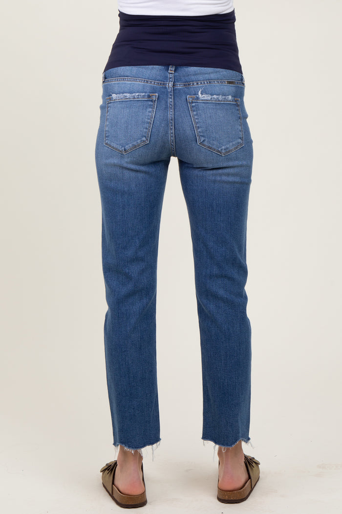 maternity wear woman wearing a pair of blue straight leg jeans with a frayed hem and a stretchy black waistband