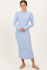 woman wearing a light blue ribbed long sleeve midi dress with a fitted silhouette and round neckline