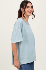 woman wearing a light blue oversized t-shirt with a relaxed fit and short sleeves