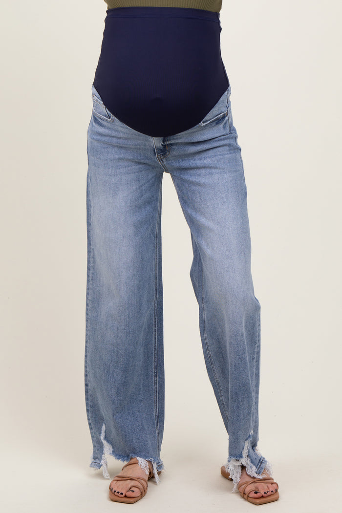 woman wearing light blue distressed maternity jeans with a dark blue over-the-bump band