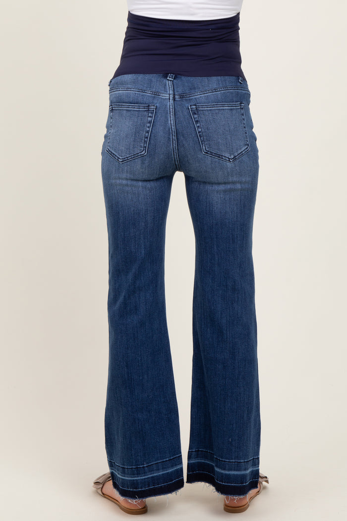 woman wearing dark wash flared maternity jeans, view of the back, featuring a stretchy waistband