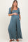 woman wearing a floral print maternity maxi dress with a square neckline and puff sleeves, holding her baby bump