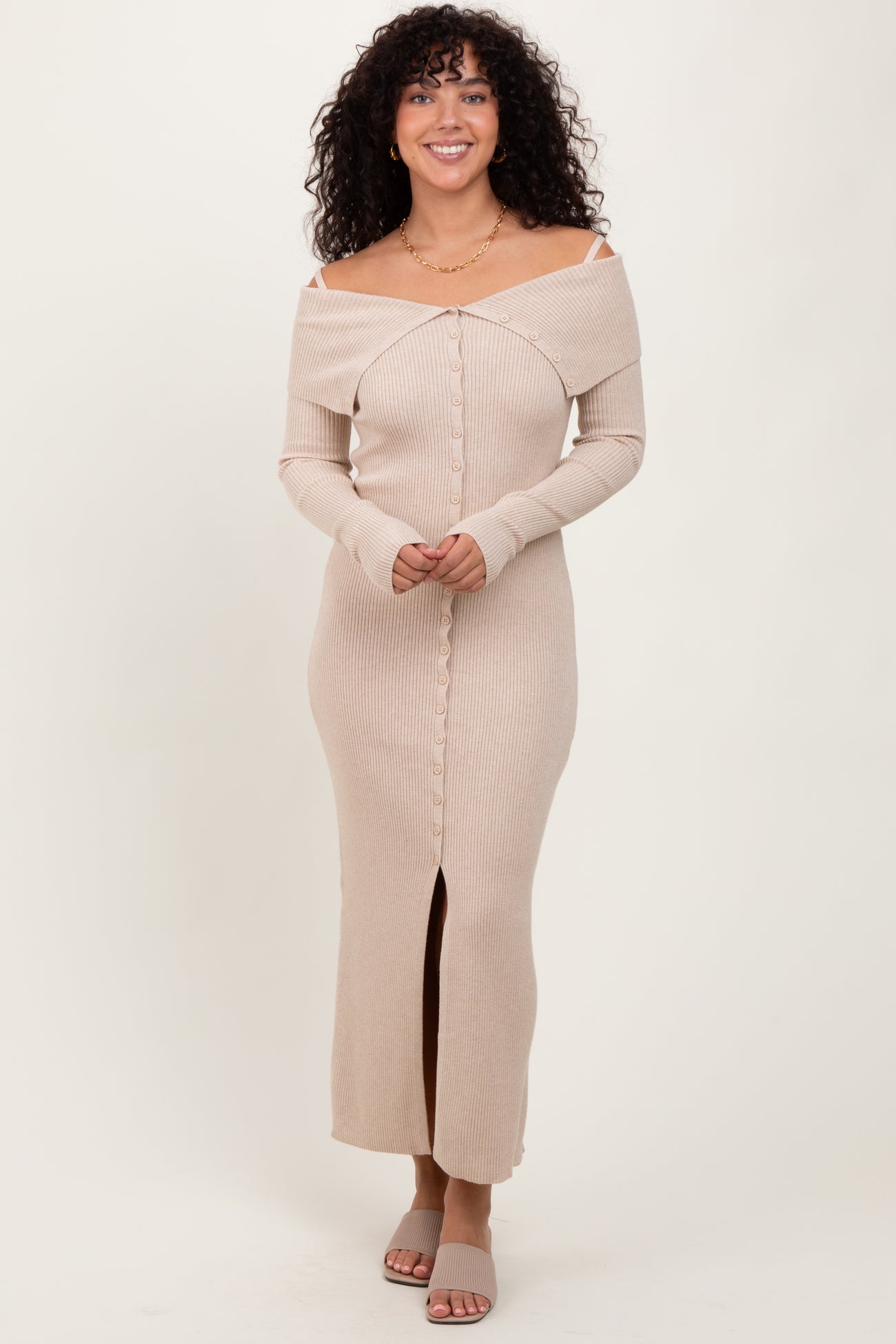 woman wearing a beige off-the-shoulder ribbed maxi dress with a button-down front and a thigh-high slit